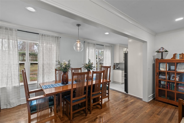 dining room featuring hardwood / wood-style flooring and crown molding