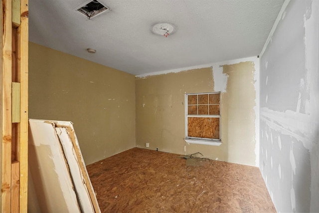 spare room with a textured ceiling