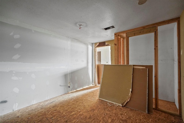 empty room featuring a textured ceiling