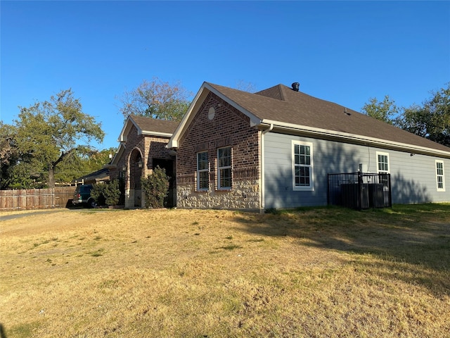 view of side of home featuring a lawn