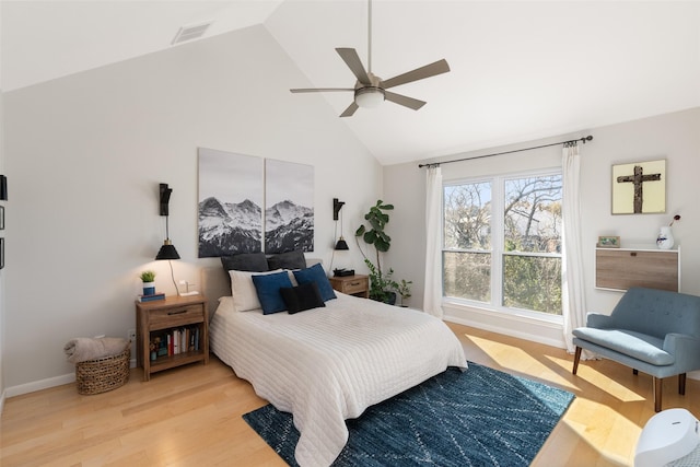 bedroom featuring ceiling fan, high vaulted ceiling, and hardwood / wood-style floors