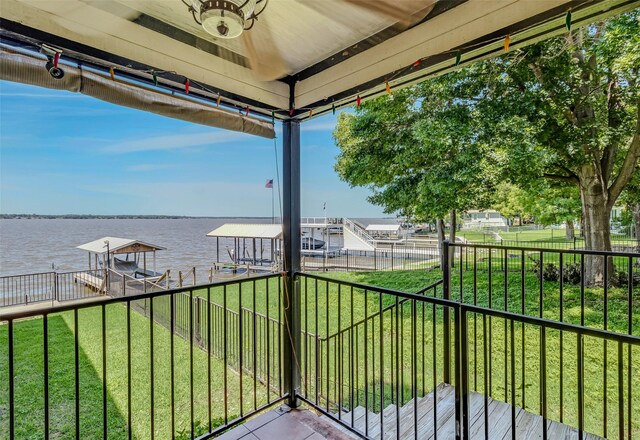 balcony featuring a boat dock and a water view