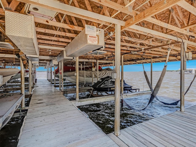 view of dock featuring a water view and boat lift