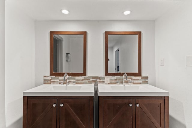 bathroom featuring vanity and backsplash