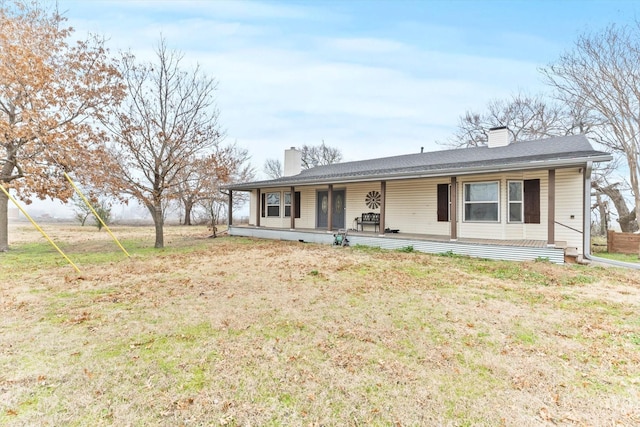 ranch-style house with a front lawn and a porch