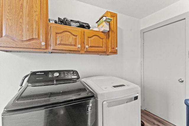 washroom with cabinets, hardwood / wood-style floors, and independent washer and dryer