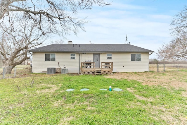 back of property featuring central AC, a lawn, and a deck