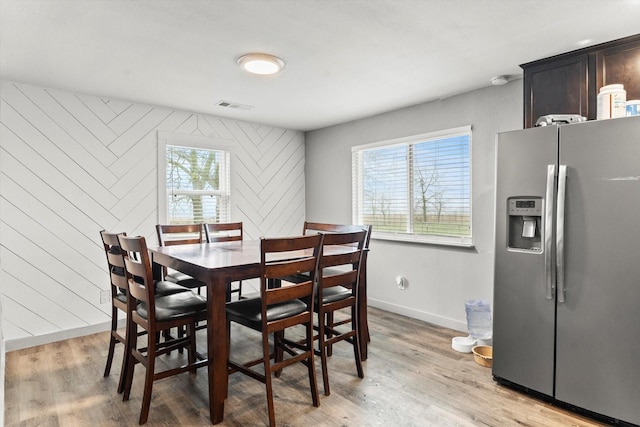 dining space with light hardwood / wood-style flooring