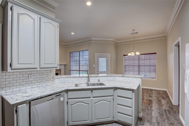 kitchen with ornamental molding, sink, stainless steel dishwasher, and kitchen peninsula