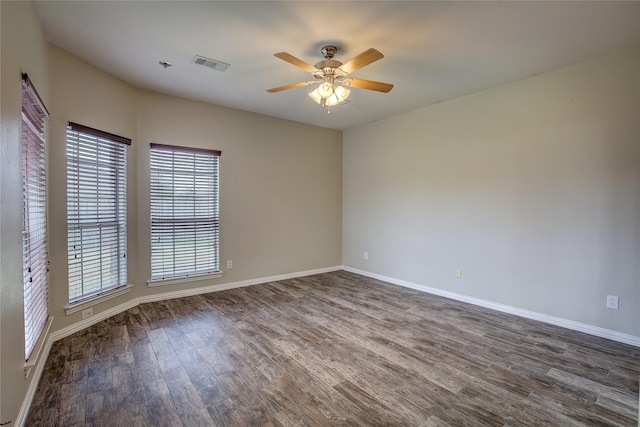 unfurnished room with dark hardwood / wood-style flooring and ceiling fan