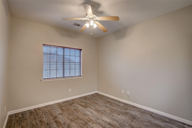 empty room with dark wood-type flooring and ceiling fan