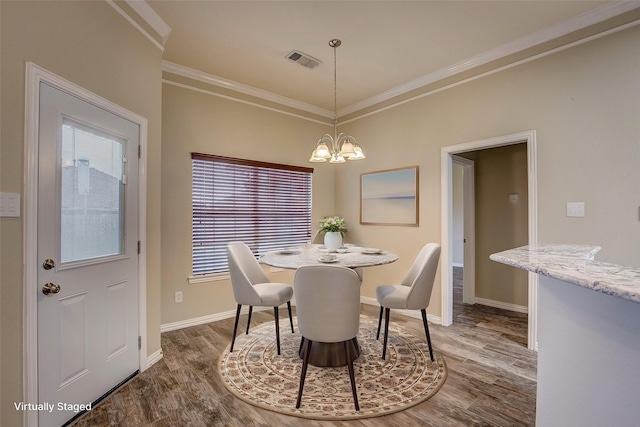 dining space with an inviting chandelier, hardwood / wood-style flooring, and ornamental molding