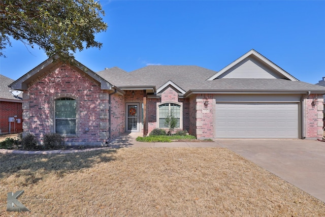 ranch-style home with a garage and a front yard