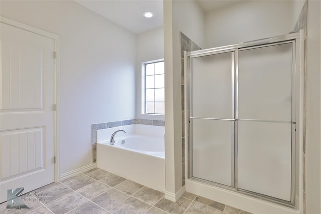 bathroom with tile patterned floors and shower with separate bathtub