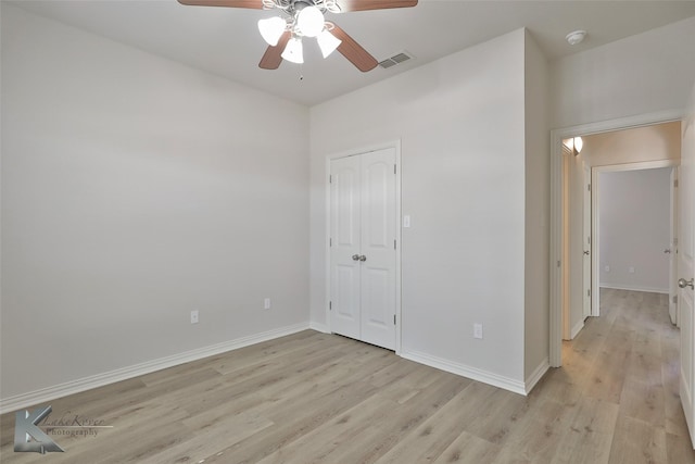 spare room with ceiling fan and light wood-type flooring