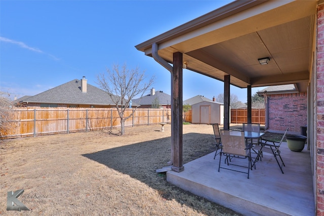 view of yard featuring a patio and a shed