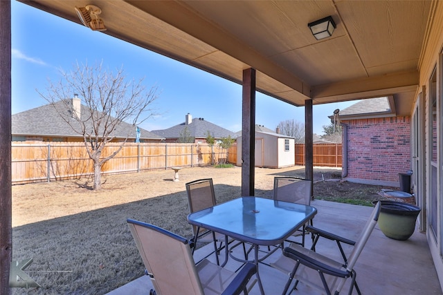 view of patio / terrace with a shed