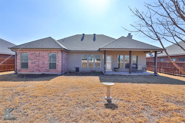 back of property featuring a yard and a patio