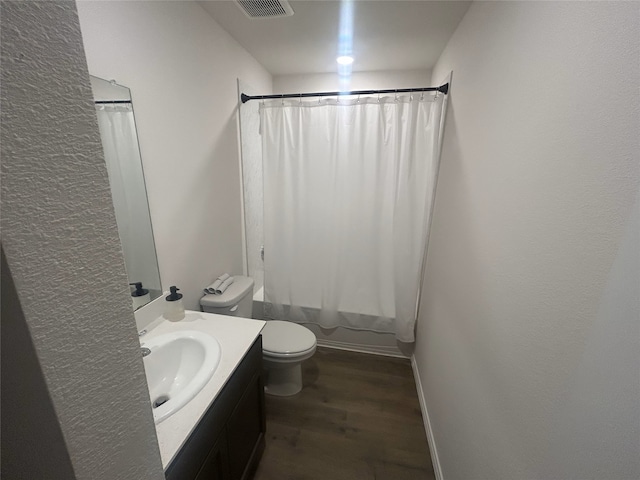 full bathroom featuring vanity, wood-type flooring, toilet, and shower / tub combo with curtain