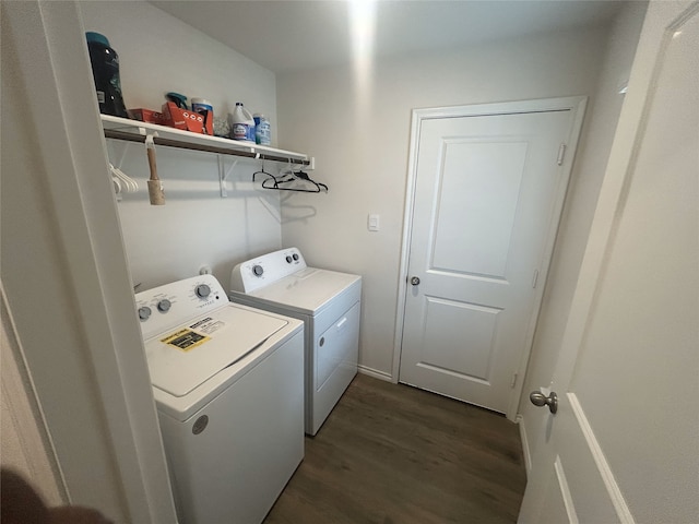 laundry room with dark hardwood / wood-style flooring and washing machine and dryer