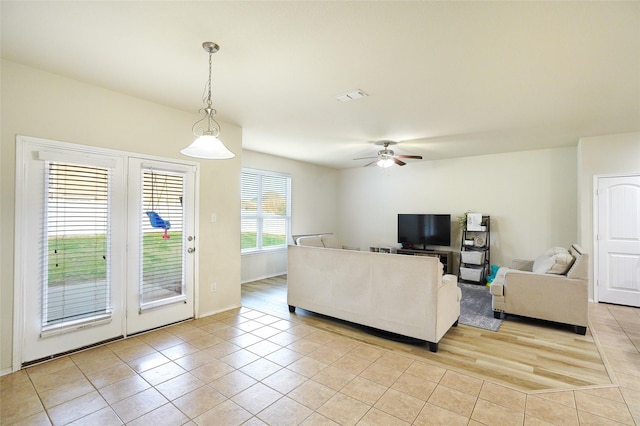 tiled living room featuring ceiling fan