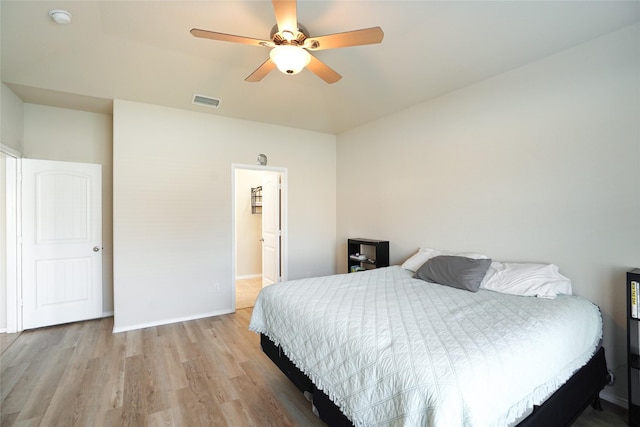 bedroom with light hardwood / wood-style floors and ceiling fan