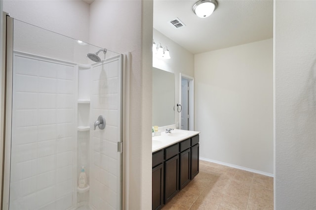 bathroom with vanity and a shower