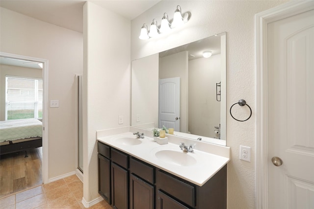 bathroom with vanity, a shower with door, and tile patterned flooring