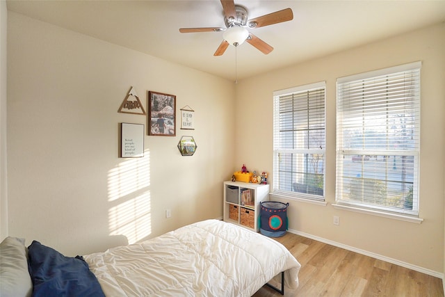 bedroom with ceiling fan and light wood-type flooring