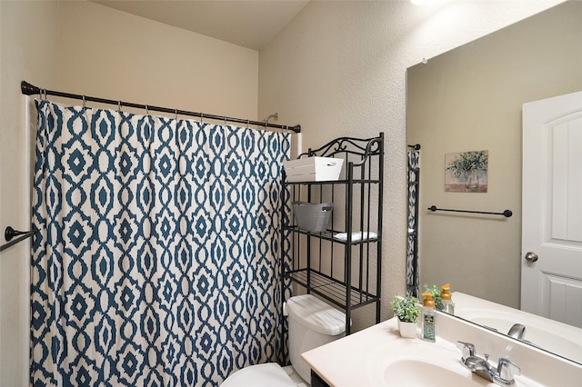 bathroom featuring a shower with curtain, vanity, and toilet