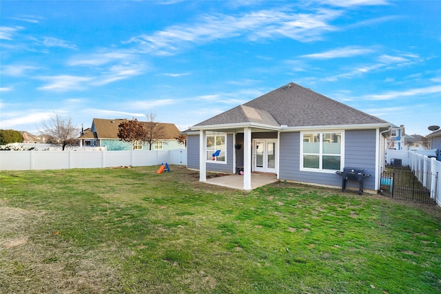 rear view of house featuring a patio and a lawn