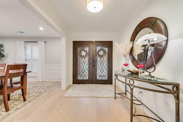 entrance foyer featuring french doors and light hardwood / wood-style flooring