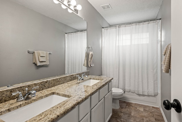 full bathroom featuring vanity, toilet, shower / tub combo, and a textured ceiling