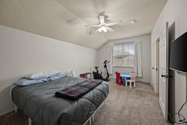 bedroom with vaulted ceiling, carpet, ceiling fan, and a textured ceiling