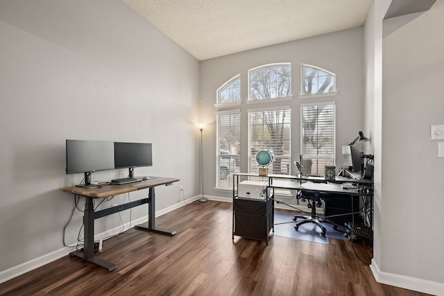 home office featuring vaulted ceiling, a textured ceiling, and dark hardwood / wood-style flooring