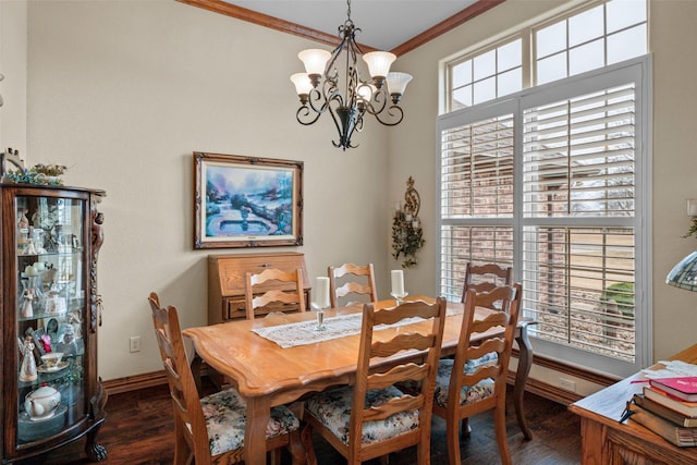 dining area featuring crown molding, a chandelier, and dark wood-type flooring