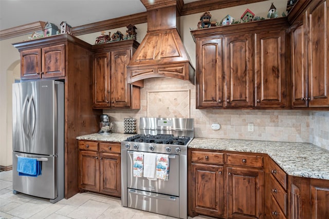 kitchen featuring backsplash, crown molding, custom exhaust hood, and stainless steel appliances