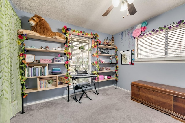 home office featuring ceiling fan, light carpet, and a textured ceiling