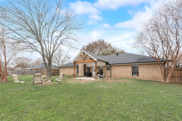 rear view of house with a lawn, ceiling fan, and a patio area