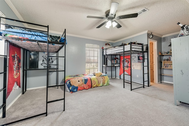 carpeted bedroom featuring ceiling fan, ornamental molding, and a textured ceiling