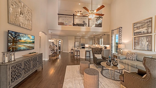 living room featuring ceiling fan and hardwood / wood-style floors