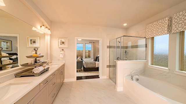 bathroom featuring vanity and shower with separate bathtub