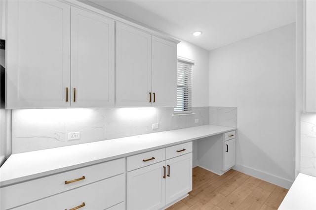 kitchen featuring tasteful backsplash, white cabinetry, and light hardwood / wood-style floors