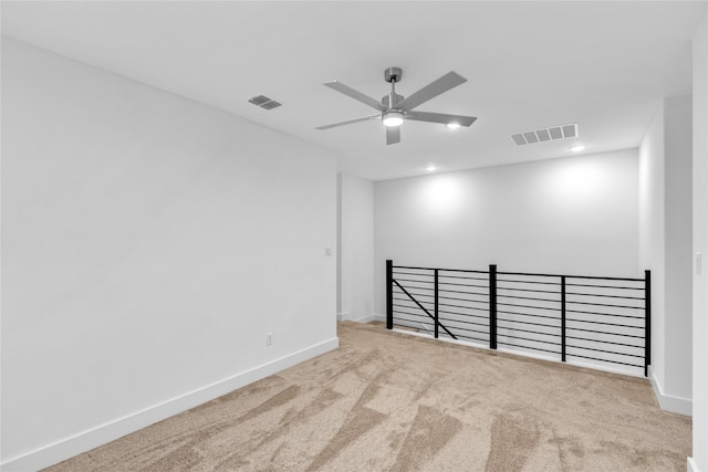 unfurnished room featuring ceiling fan and carpet floors