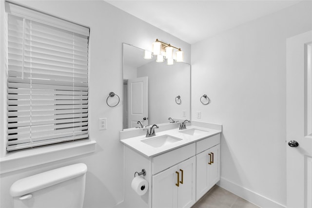 bathroom with tile patterned floors, vanity, and toilet