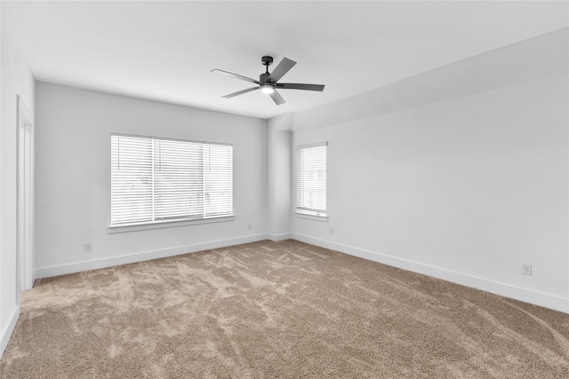 carpeted empty room featuring ceiling fan