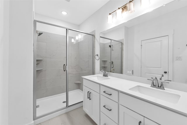 bathroom with vanity and a shower with shower door