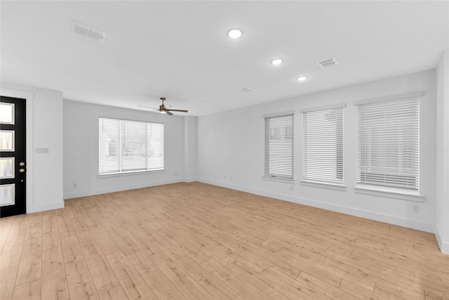 empty room featuring ceiling fan and light hardwood / wood-style flooring