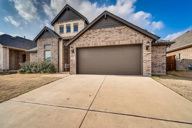 view of front of property with a garage and a front lawn