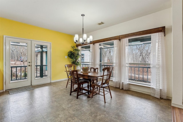 dining space with french doors, baseboards, visible vents, and an inviting chandelier